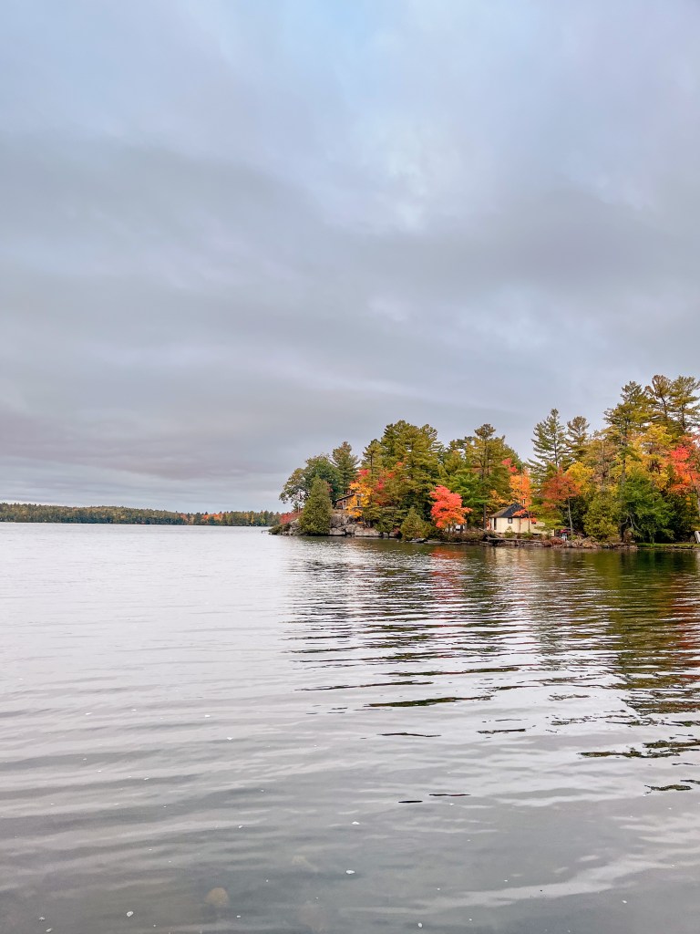 Oak Lake with Fall coloured leaves in the background.