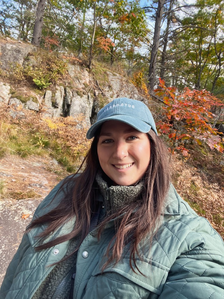 Woman enjoying fall hiking trail in Ontario. Best place to view fall colours in Ontario.